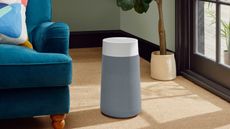 Blue 3250i Blueair air purifier in living room next to teal sofa