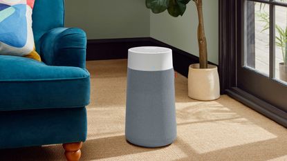 Blue 3250i Blueair air purifier in living room next to teal sofa