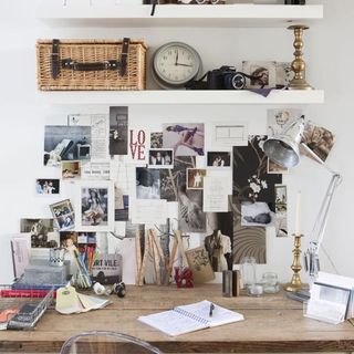 room with white wall and photos and wooden desk