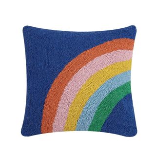 A navy blue pillow with a rainbow decoration