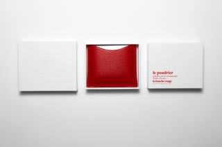 Red compact make up with packaging either side