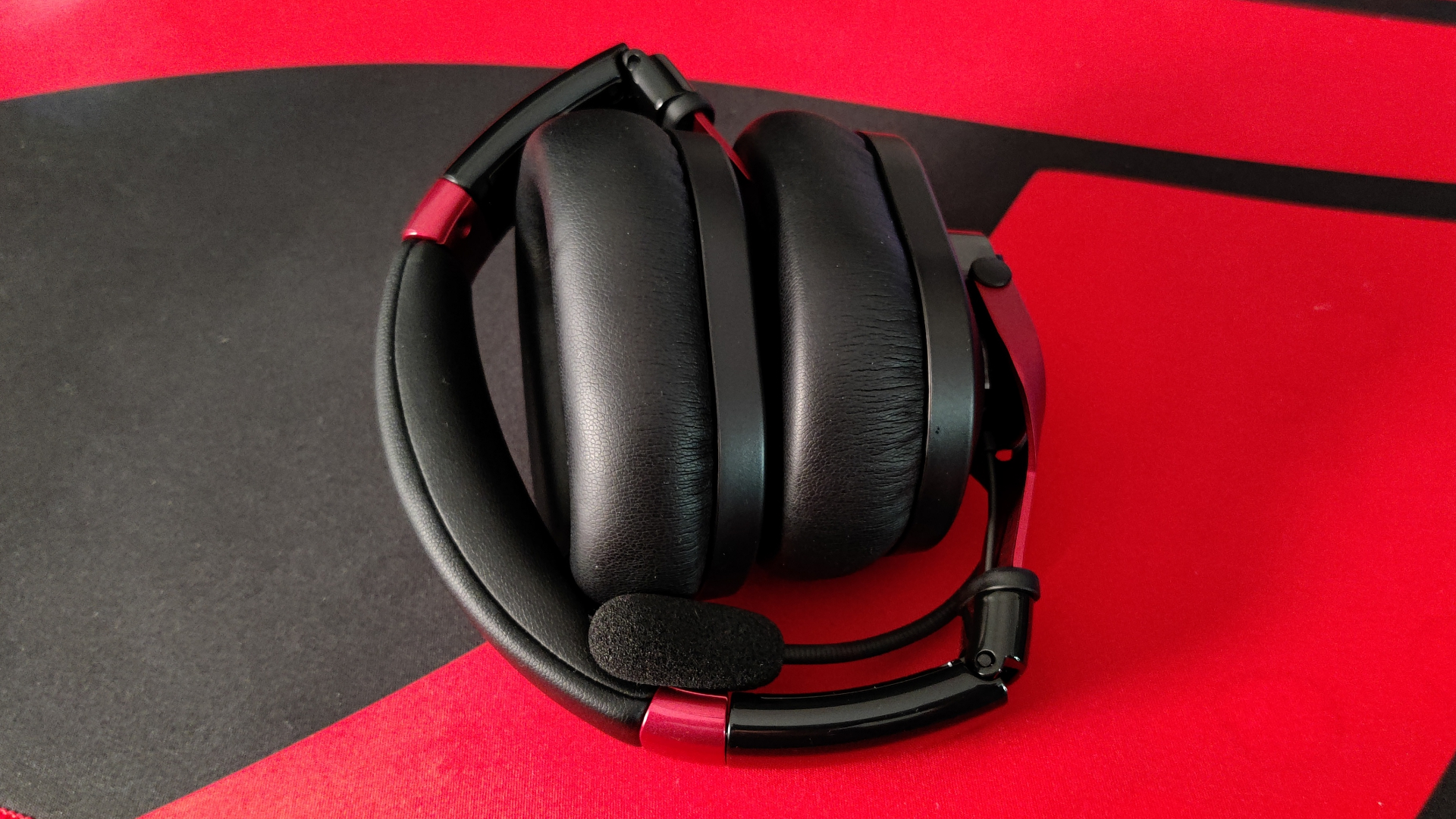 The austrian audio pg16 folded up on a red and black desk.