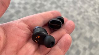 Bowers & Wilkins Pi8 wireless in-ear headphones held in hand