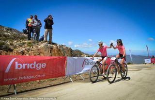 Team RE:CM Davinci's Annika Langvad (left) and Arian Kleinhans celebrate winning Stage 2 of the Cape Pioneer Trek at the summit of the monstrous ascent of the Swartberg Pass. The first women to the summit of this stage at the 2014 edition will get R250,000 in prize money, which is equal to that given to the winning men's team.