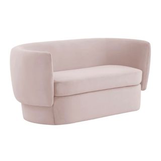 A pale pink curved sofa