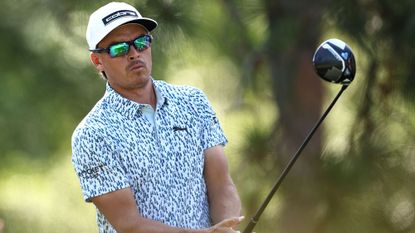 Rickie Fowler in sunglasses with a driver in his hands