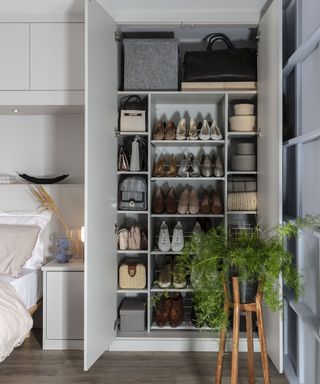 bedroom with storage solutions, closet with multiple shelving for shoes, large items and baskets