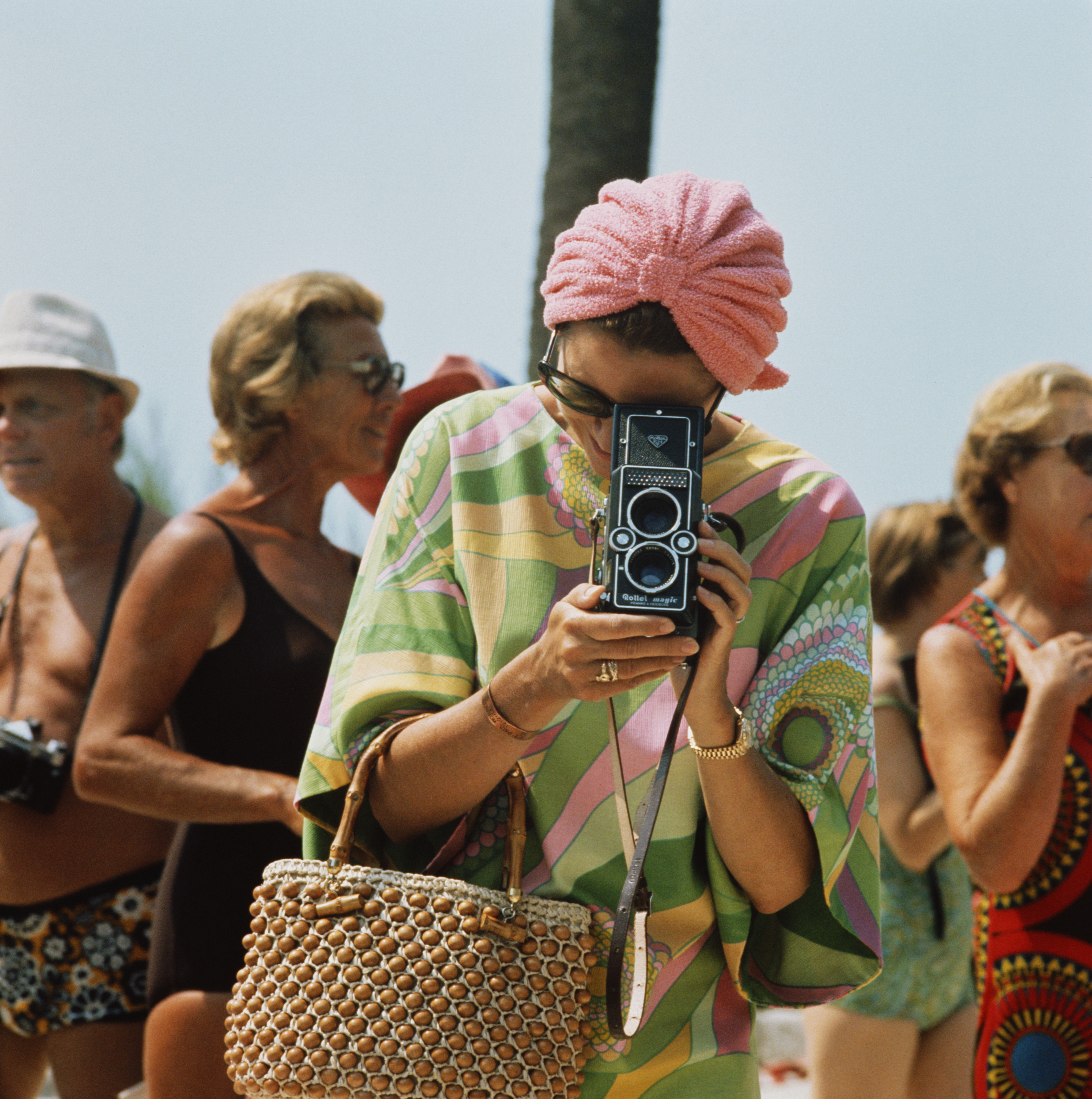 1972: Princess Grace of Monaco taking a photograph with a Rollei Magic twin lens reflex camera at a swimming competition at the Monte Carlo Beach Club near the Monte-Carlo Beach hotel. (Photo by Hulton Archive/Getty Images)