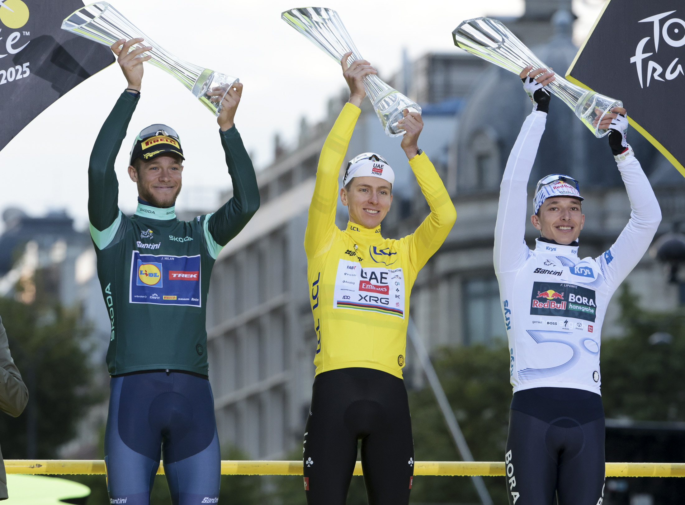 PARIS, CHAMPS-ELYSEES, FRANCE - JULY 27: From left, green jersey for &#039;best sprinter&#039; Jonathan Milan of Italy and Lidl - Trek,Tour winner&#039;s yellow jersey Tadej Pogacar of Slovenia and UAE Team Emirates - XRG, white jersey of &#039;best young rider&#039; Florian Lipowitz of Germany and Red Bull - BORA - hansgrohe during the final podium ceremony following Stage 21 of the 112th Tour de France 2025, a 132,3 km stage from Mantes-la-Ville to Paris, Champs-Elysees on July 27, 2025 in Paris, France. (Photo by Jean Catuffe/Getty Images)