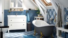 small bathroom storage bathroom with freestanding bath, vanity with drawers and open shelves