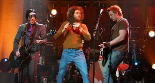 Troy Van Leeuwen and Josh Homme of QOTSA perform on Saturday Night Live with Will Ferrell on the cowbell.