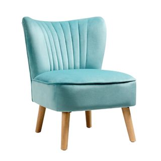 A green velvet accent chair with wooden legs
