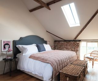 loft bedroom with exposed brick wall and bedroom furniture