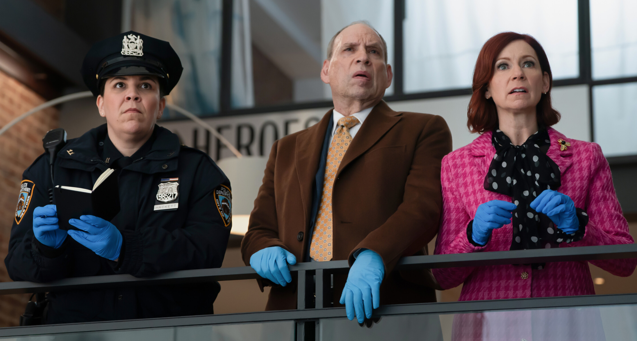 Lindsay Mendez as Officer Grace Hackett, Daniel Oreskes as Detective Buzz Fleming, and Carrie Preston as Elsbeth Tascioni standing on a ledge wearing gloves while investigating in elsbeth season 3