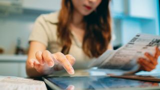 A woman checking her energy bills and using an iPad