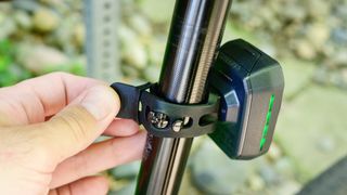 The Trek CarBack Radar Rear Bike Light being affixed to a seat post using the rubber strap