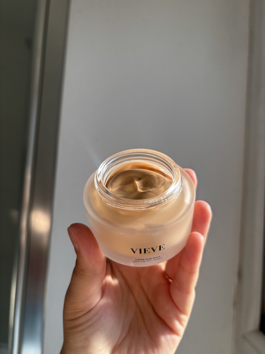 Mica Ricketts holding open pot of Vieve Super Skin Nova