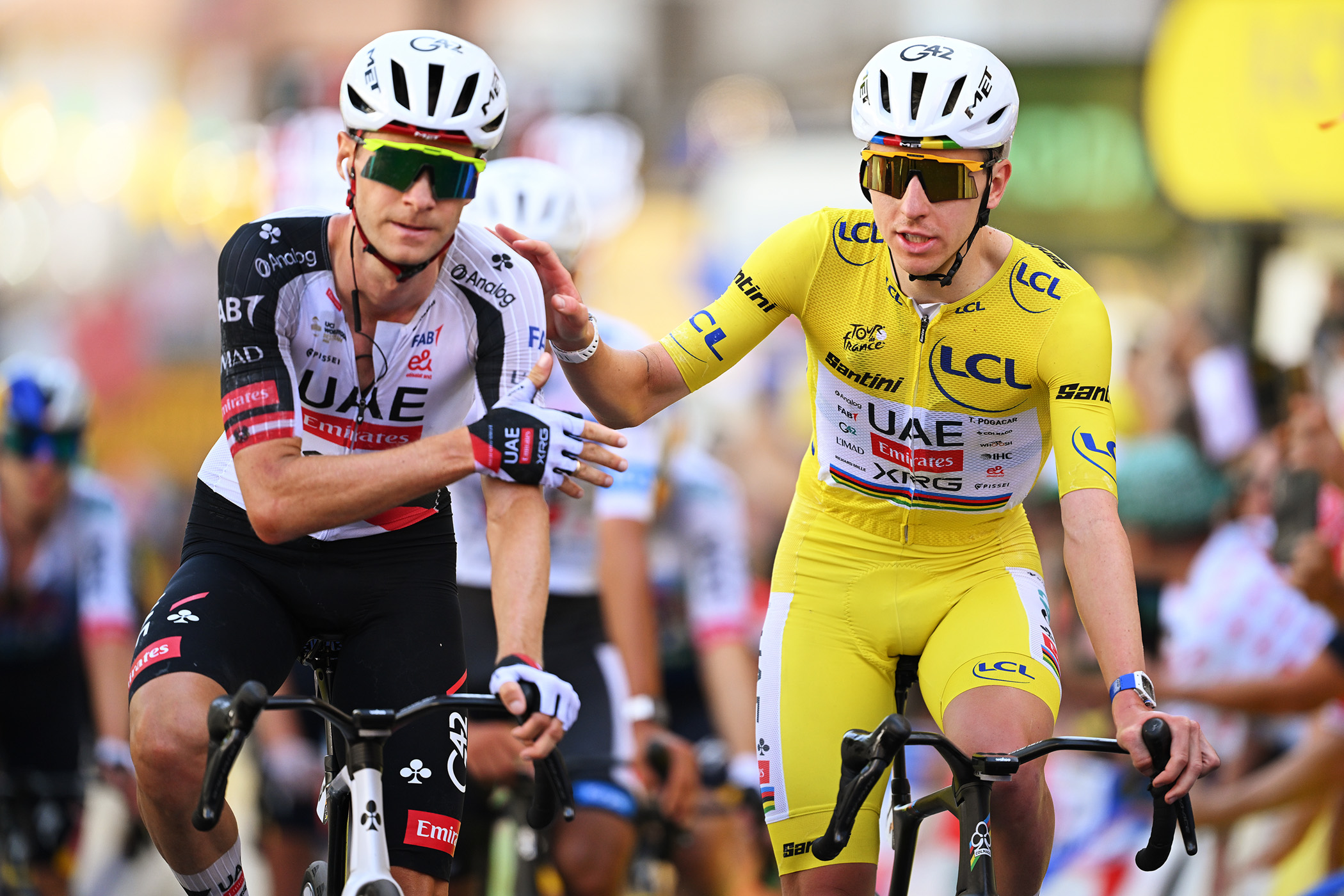 Felix Gro&szlig;schartner races alongside yellow jersey Tadej Pogačar at the 2026 Tour de France