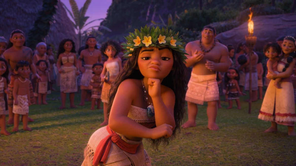 Moana stands in the middle of a ceremonial dance with a sassy look in Moana 2. 