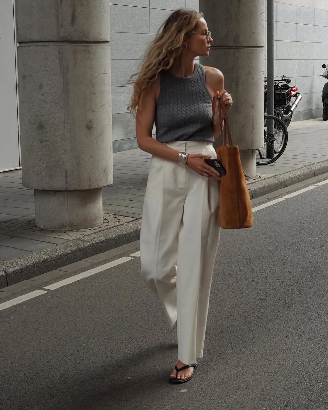 Woman wearing trouser pants and flip flops summer 2025.