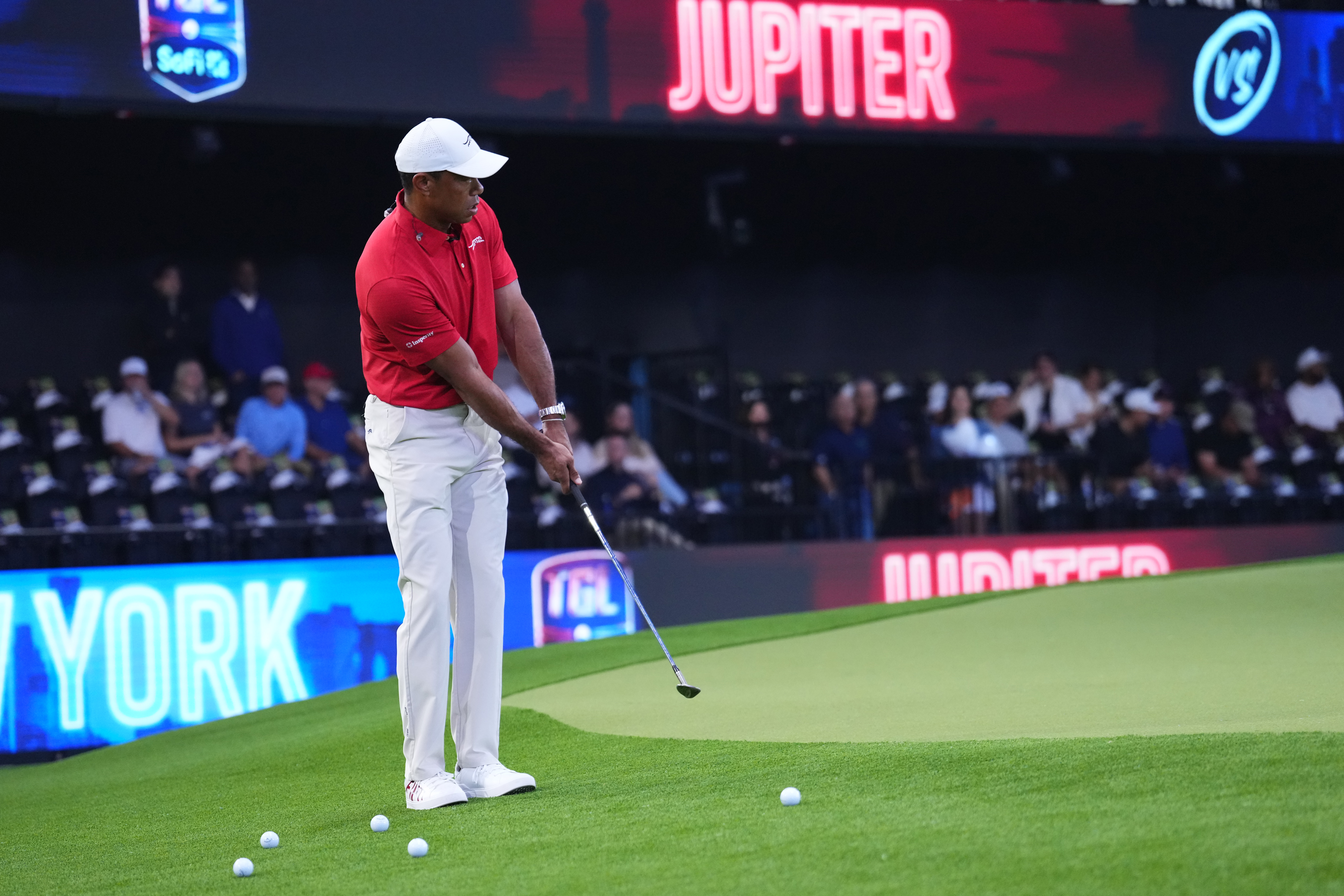 Tiger Woods hits a chip shot before a TGL match