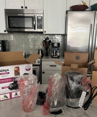 Unboxing the Ninja Fit blender in modern kitchen on white marble countertop