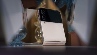 The back of the gold Galaxy Z Flip 4 reflected in the display of the Galaxy Z Fold 4