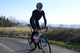 Image shows a rider cycling in winter.
