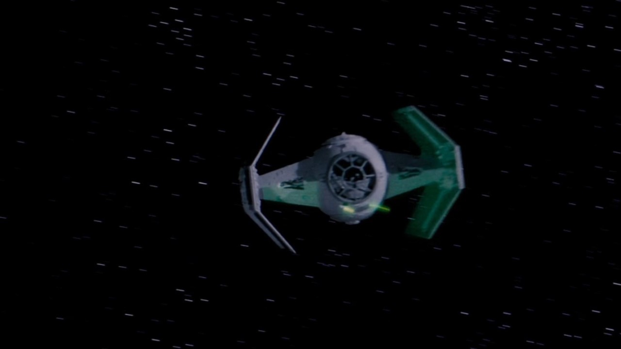 Darth Vader's TIE Fighter flying through space in Star Wars: A New Hope