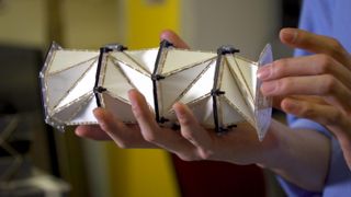 A paper model of a chain of origami-inspired metamaterials to soften impact forces.