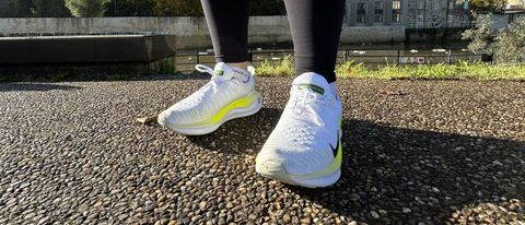 Woman's feet wearing Nike Infinity Run Flyknit 4 road running shoes - front view