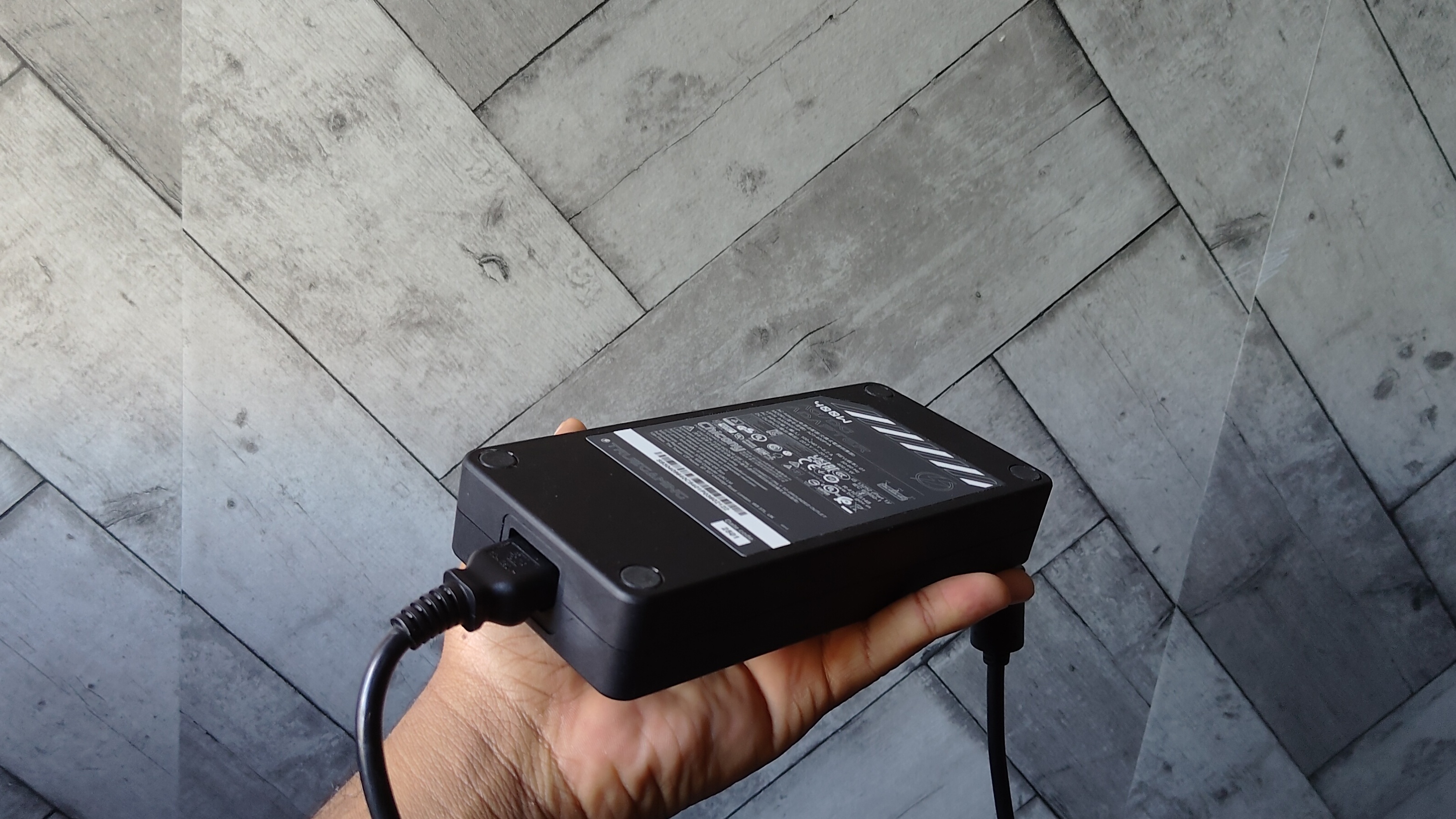 Male holding the MSI Vector A18 HX A9W's adapter