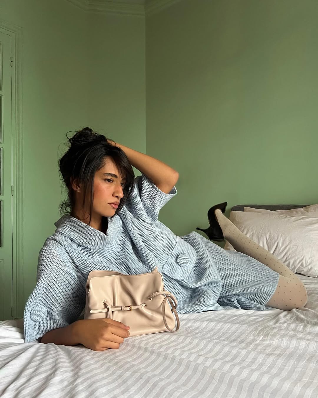 Emna Sellimi in a baby blue sweater dress.