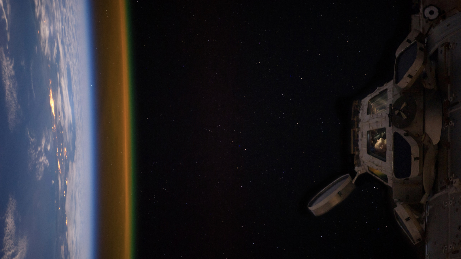 An image of astronaut Don Pettit looking at the Earth from the ISS Cupola