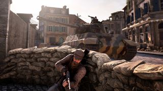 The Sniper Elite protagonist hides from a tank behind cover