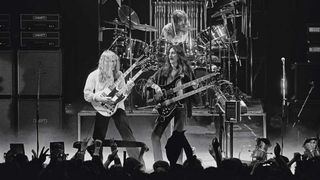 Guitarist Alex Lifeson, bassist Geddy Lee and (behind) drummer Neil Peart from Canadian progressive rock band Rush perform live on stage at the Odeon in Birmingham, England during their 'Farewell To Kings' tour on 12th February 1978