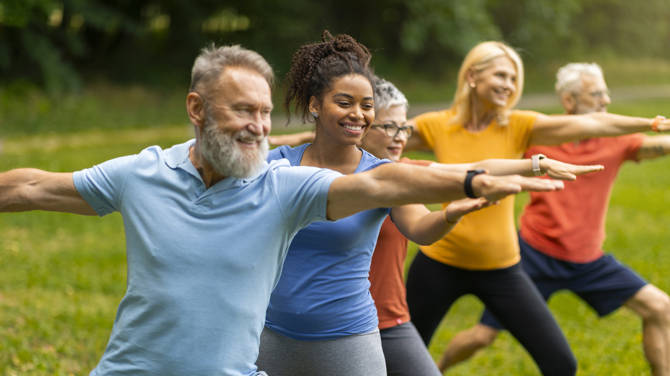 Older adults doing yoga in a park