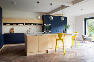 A kitchen with light wooden floors and plywood fittings