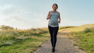Can you run while pregnant? Image shows pregnant runner