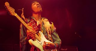 Jimi Hendrix plays a white Fender Stratocaster under the stage lights at the Royal Albert Hall