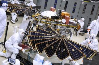 Technicians unfurl the InSight Mars lander's solar arrays during a key test at a Lockheed Martin Space Systems facility in Colorado on Jan. 23, 2018.