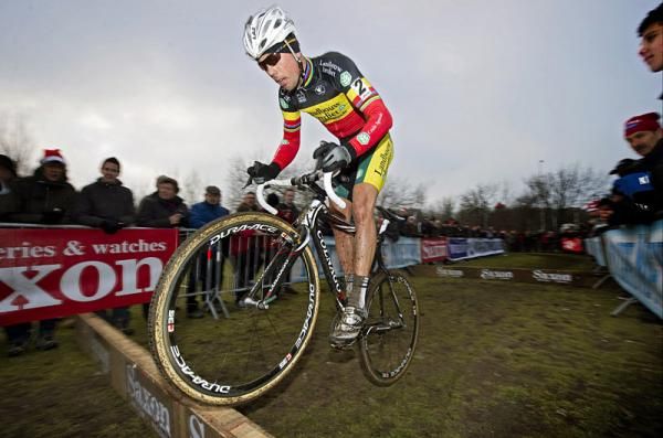 Belgian champion Sven Nys bunnyhops a barrier.