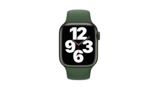 Front view of Apple Watch Series 7 with green strap on white background, display showing analogue clock face