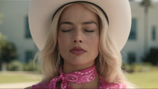 Margot Robbie closing her eyes in cowboy outfit in Barbie