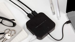 Belkin Thunderbolt 3 Dock Core, one of the best docks for MacBook Pro, on a cluttered desk connected to laptop
