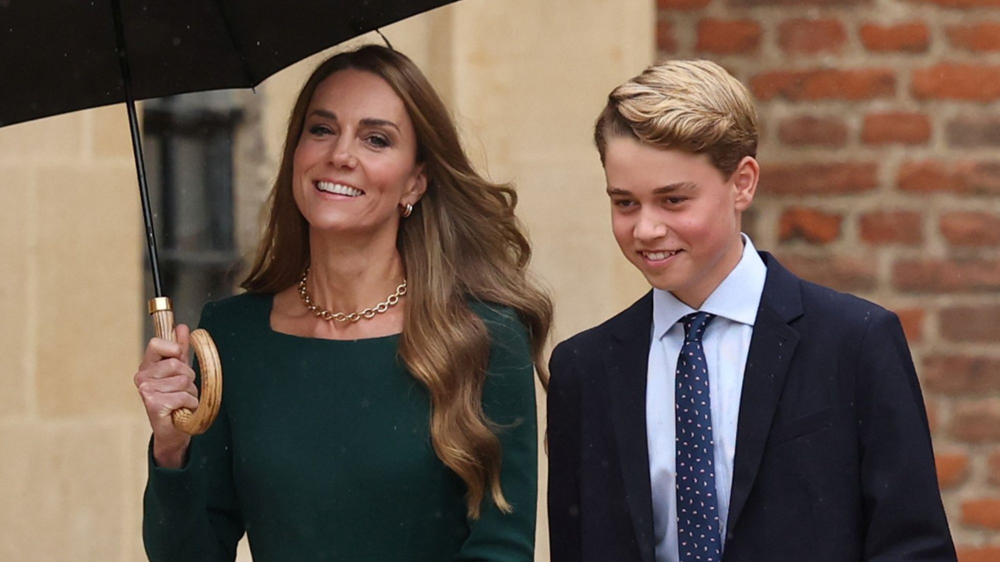 Catherine, Princess of Wales holds an umbrella and walks with Prince George as he arrives for his first day at Eton College on September 8, 2026 
