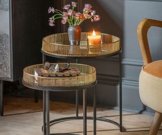 two side tables with candles and vase with pink flowers