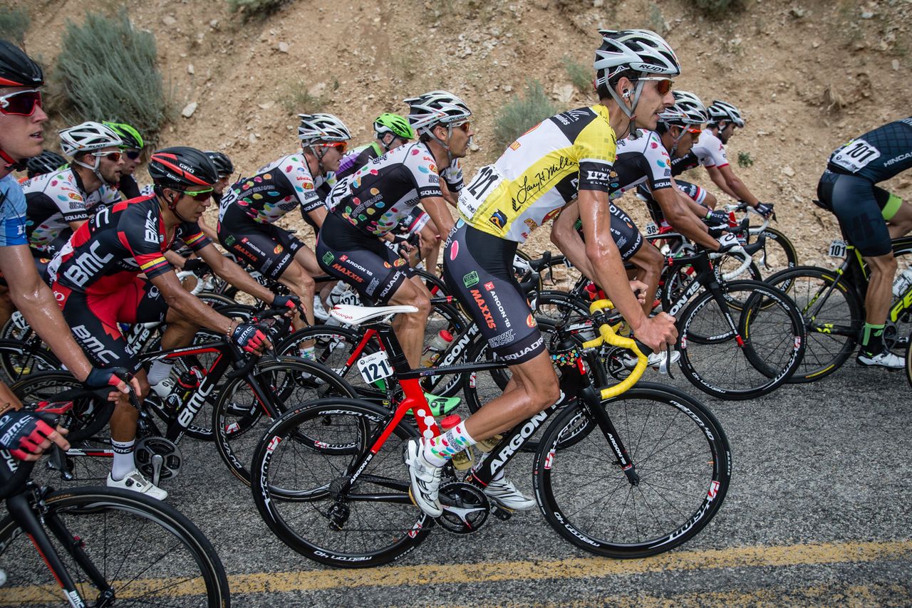 Lachlan Morton (Jelly Belly) climbs at the front of the bunch.