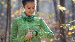 Woman checking GPS sports watch during workout