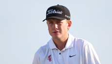 Luke Poulter walks up the fairway